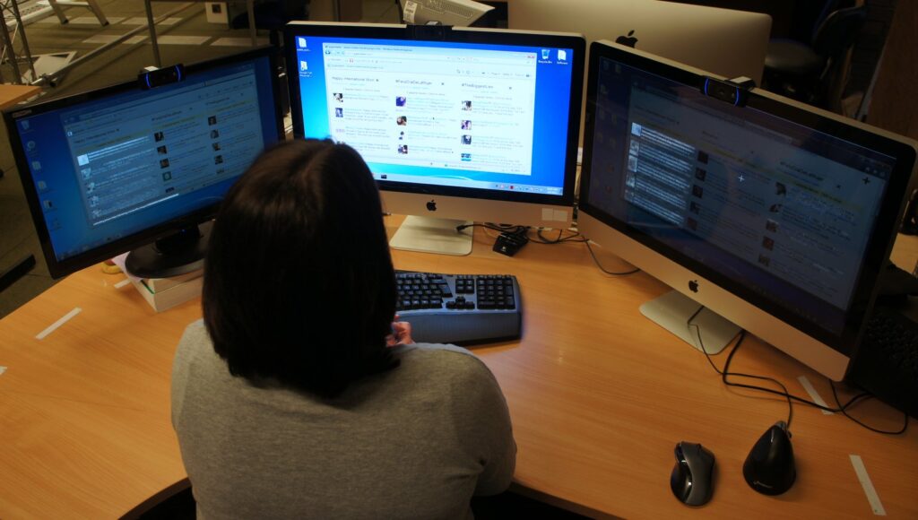 This image illustrates a typical use scenario. A person is looking at the centre display. Our system knows this and does not interfere. However, since she is not paying any attention to the other two displays, the displays are running one of our four techniques PixMap. Notice how the new tweets are highlighted in white.